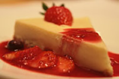 White Chocolate and Mascarpone Cheesecake with Strawberry and Rhubarb Sauce